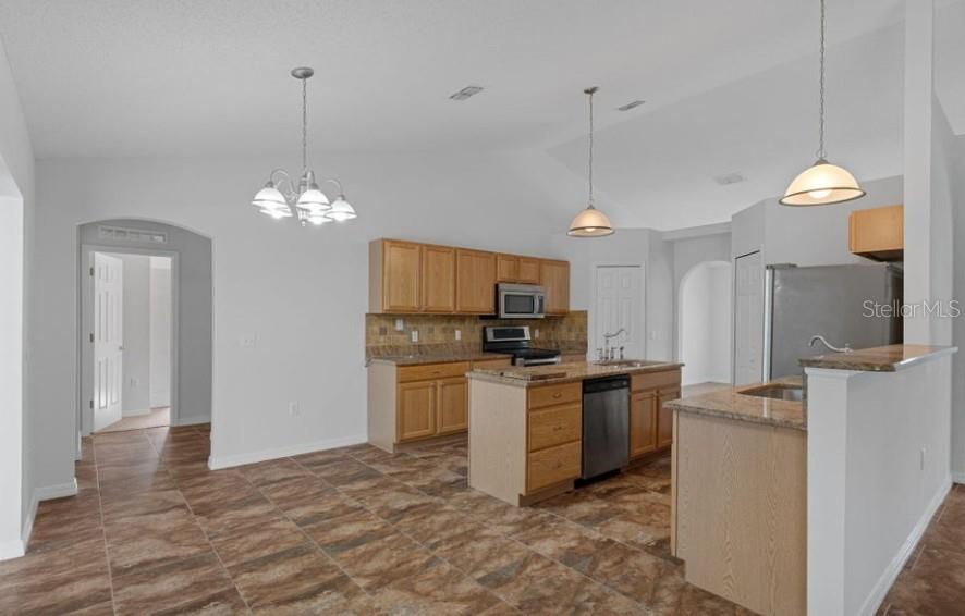 12411 Convent Garden Road Brooksville, FL 34613 - Photo 18 of 49 a kitchen that has a lot of cabinets and stainless steel appliances