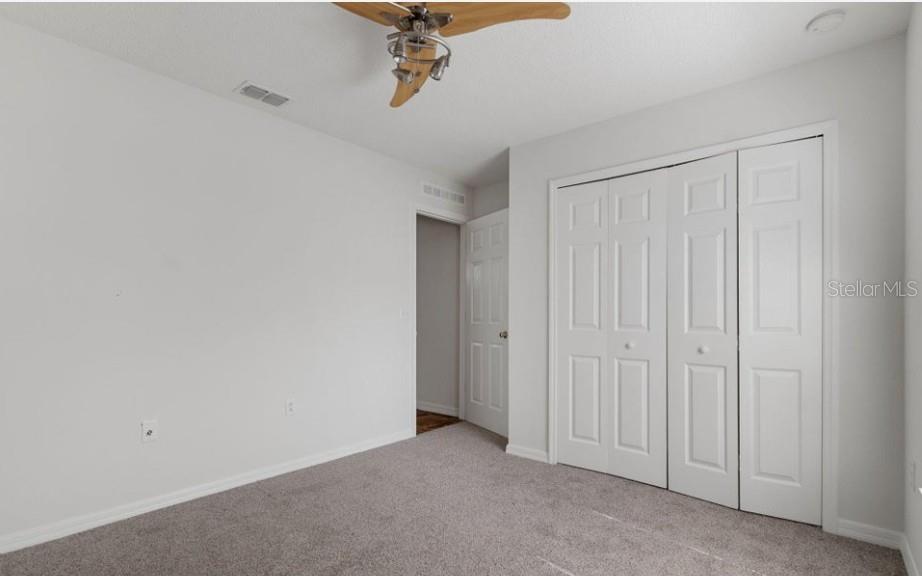 12411 Convent Garden Road Brooksville, FL 34613 - Photo 34 of 49 a view of a closet and chandelier fan in a room