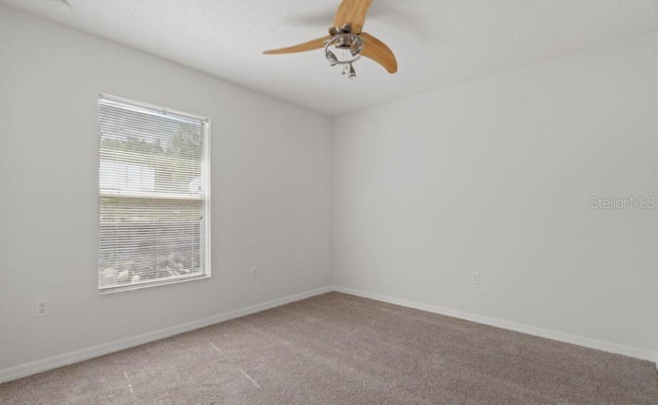 12411 Convent Garden Road Brooksville, FL 34613 - Photo 35 of 49 an empty room with windows