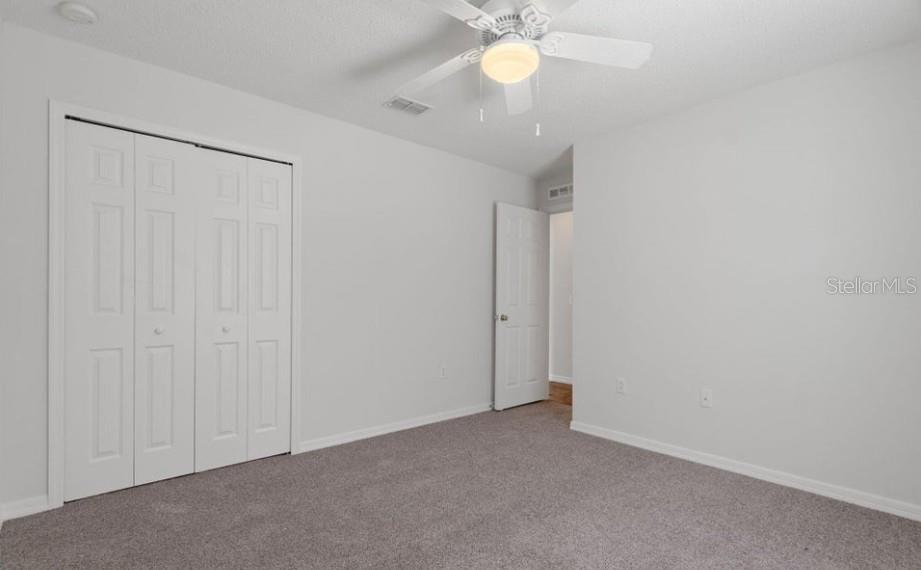 12411 Convent Garden Road Brooksville, FL 34613 - Photo 36 of 49 an empty room with a chandelier fan