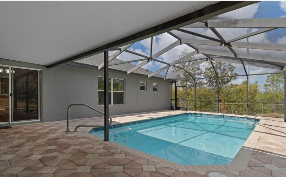 12411 Convent Garden Road Brooksville, FL 34613 - Photo 41 of 49 a view of a backyard with table and chairs