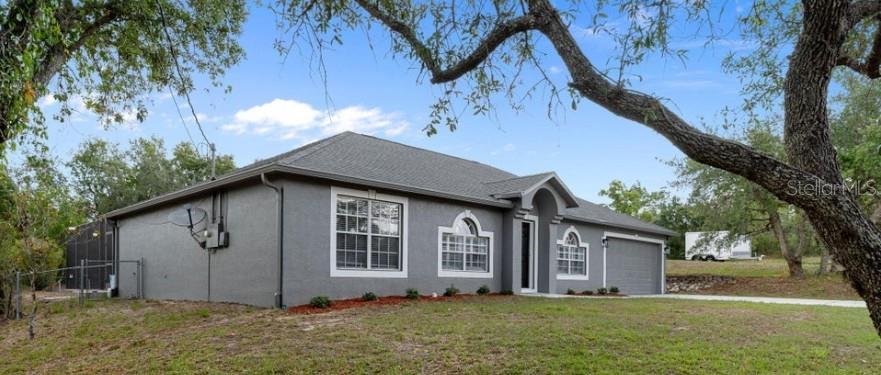 12411 Convent Garden Road Brooksville, FL 34613 - Photo 48 of 49 a front view of house with yard