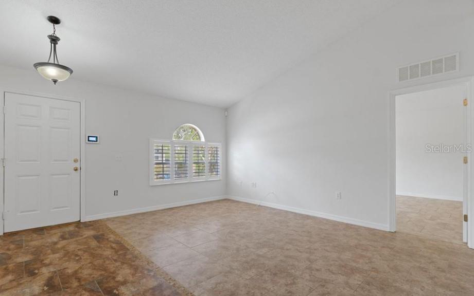 12411 Convent Garden Road Brooksville, FL 34613 - Photo 8 of 49 a view of an empty room with a window