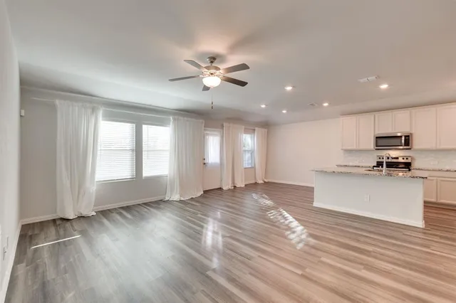 a view of kitchen with sink and wooden floor