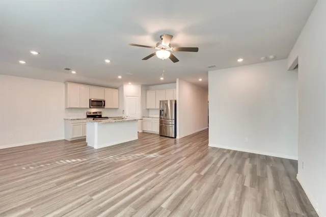 a view of kitchen with refrigerator microwave and stove