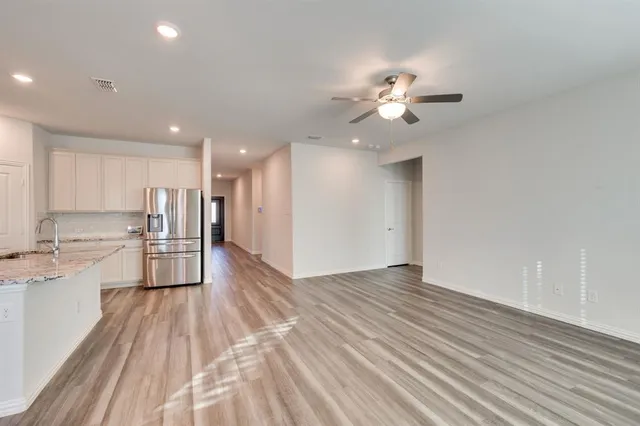 a view of kitchen with wooden floor and a window