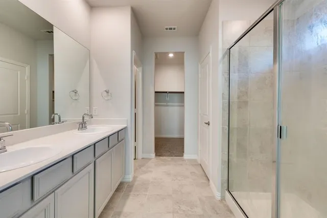 a bathroom with a granite countertop sink shower and a mirror