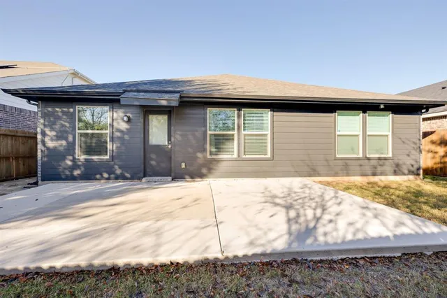 a view of a backyard with large trees