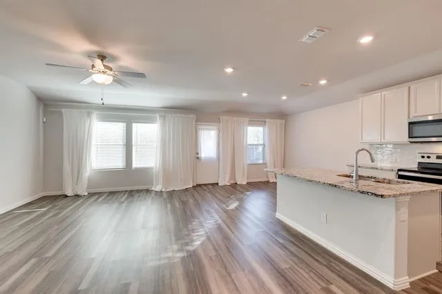 a view of kitchen with sink and wooden floor