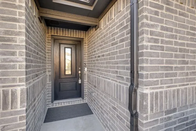 a view of a brick house with a large window