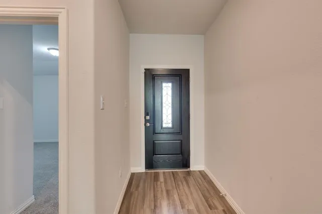 a view of a hallway view with wooden floor