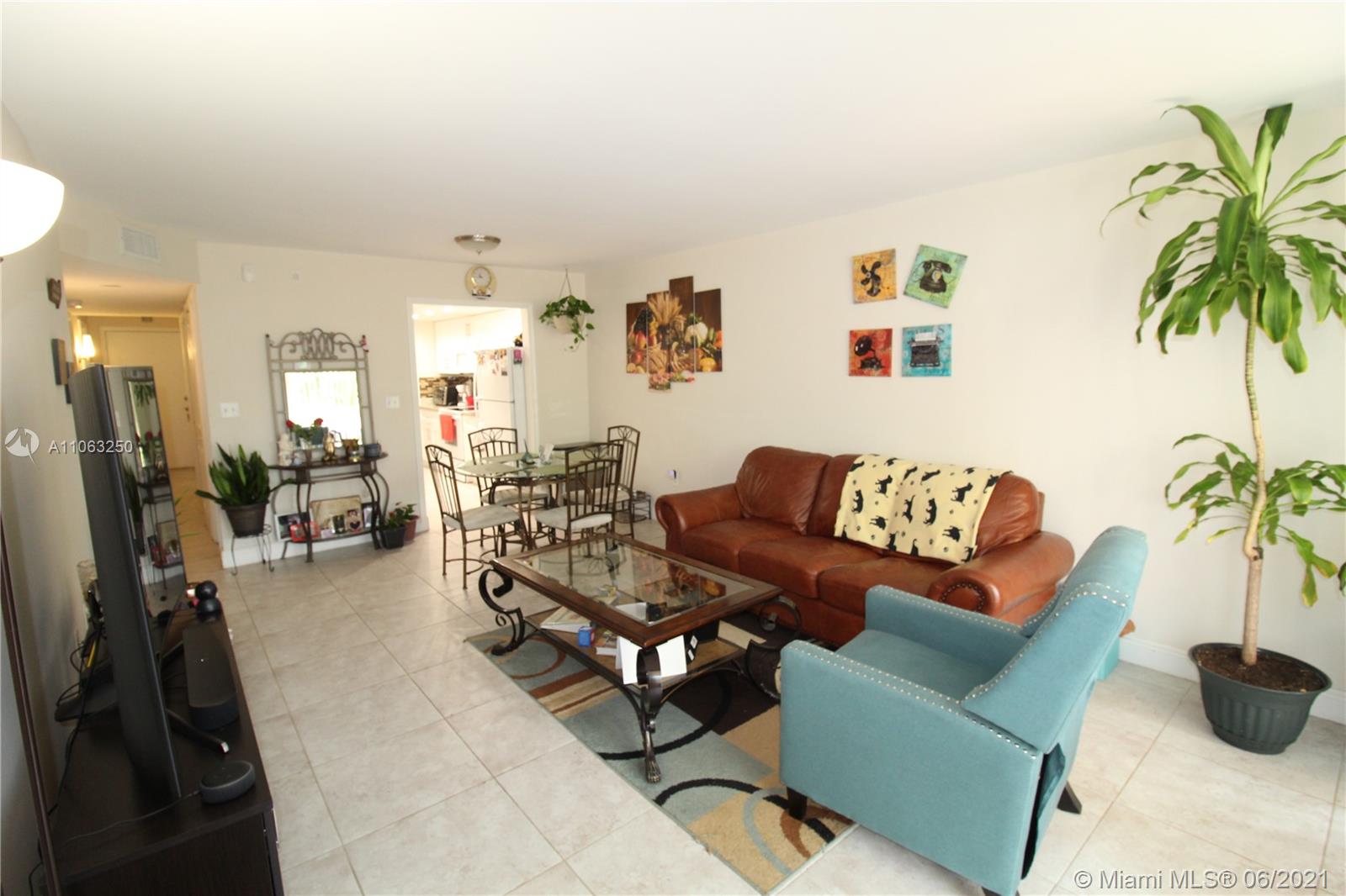 7451 Northwest 16th Street, Unit 210 Plantation, FL 33313 - Photo 4 of 16 a living room with furniture and a potted plant