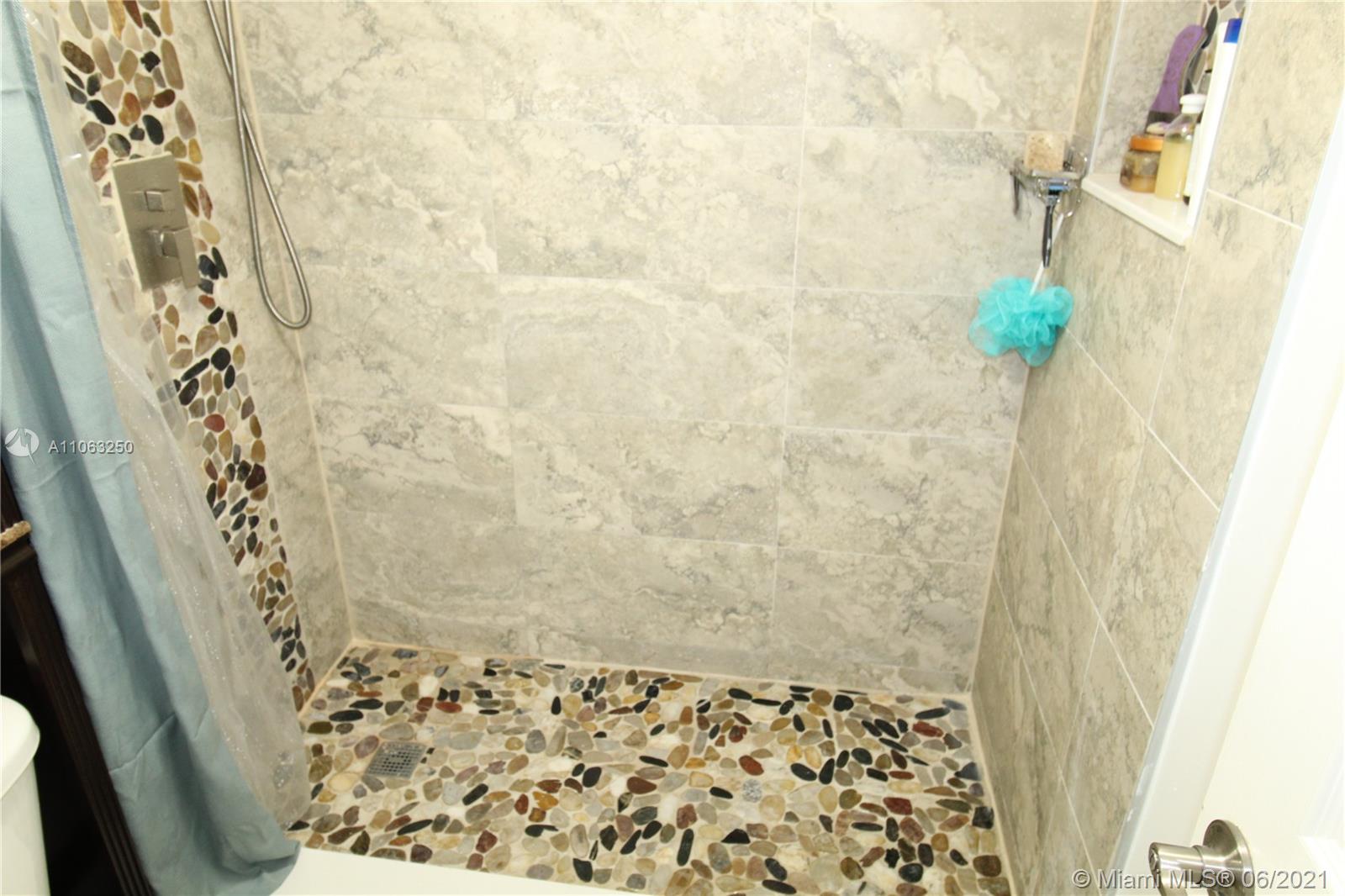 7451 Northwest 16th Street, Unit 210 Plantation, FL 33313 - Photo 9 of 16 a bathroom with a shower curtain and a sink
