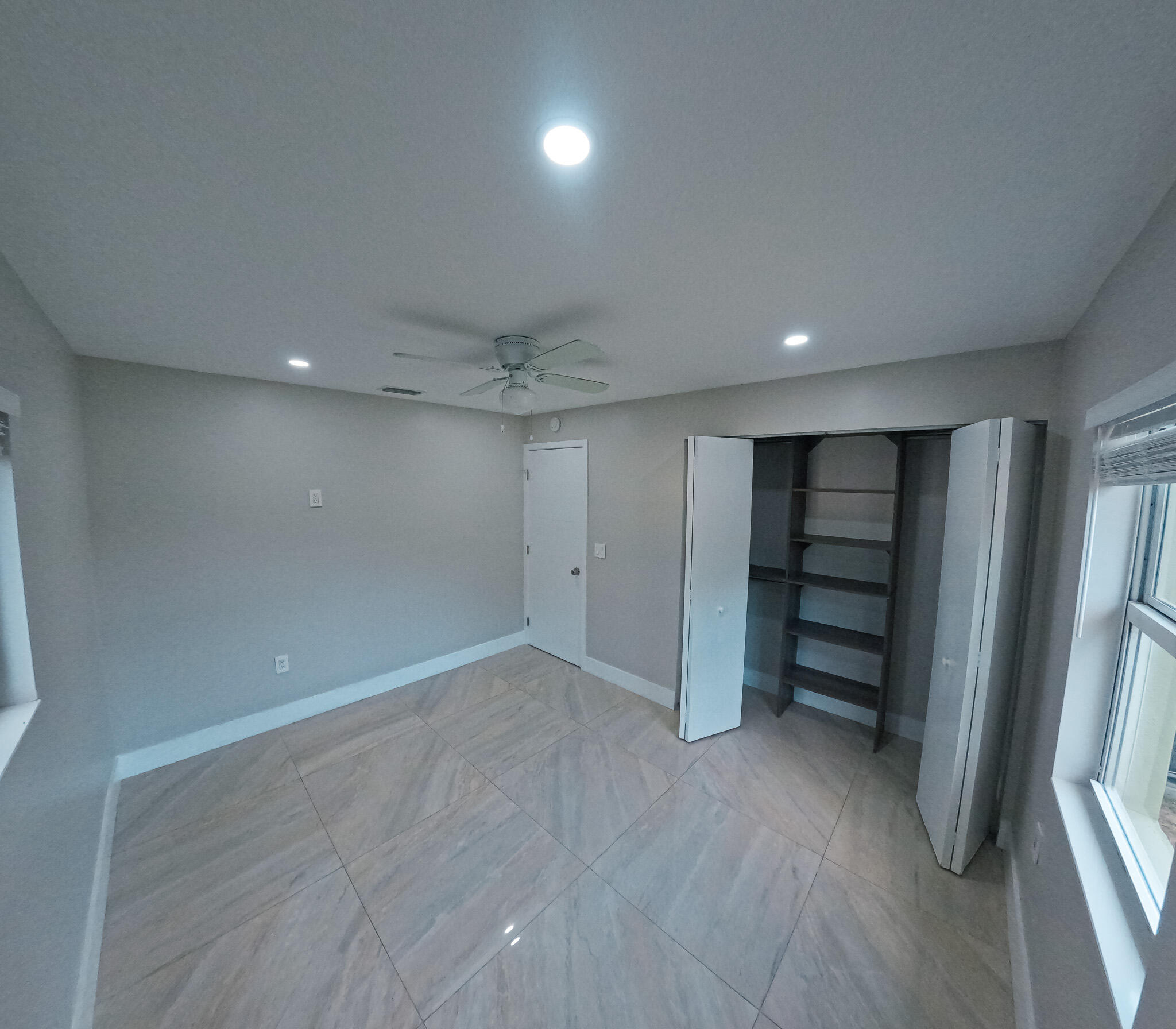 352 Johnston Street Fort Pierce, FL 34982 - Photo 11 of 28 an empty room with a cabinet and mirrors