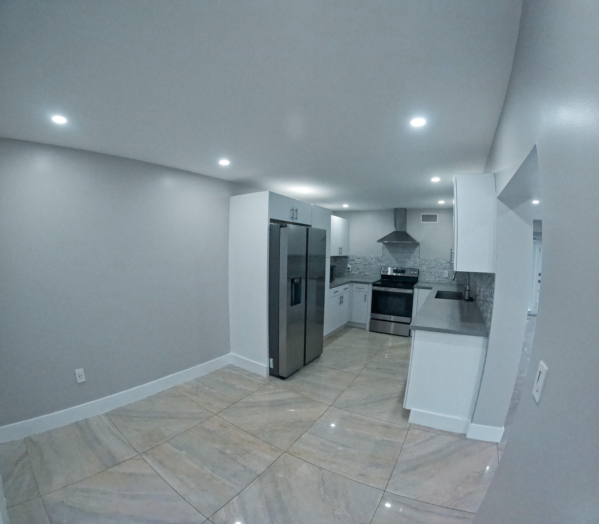 352 Johnston Street Fort Pierce, FL 34982 - Photo 12 of 28 a view of a kitchen with refrigerator and chairs