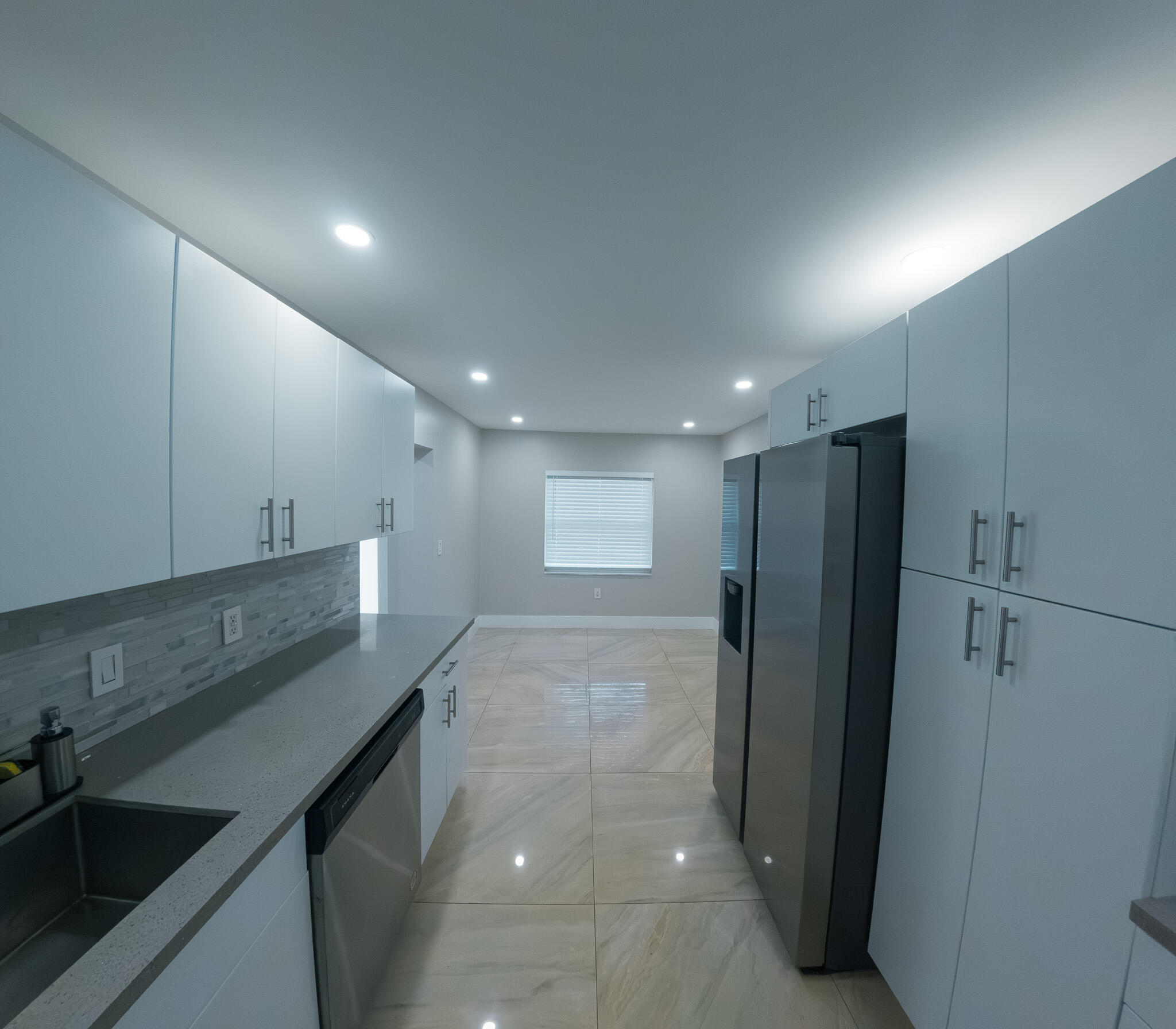 352 Johnston Street Fort Pierce, FL 34982 - Photo 13 of 28 a view of a kitchen with a sink and refrigerator