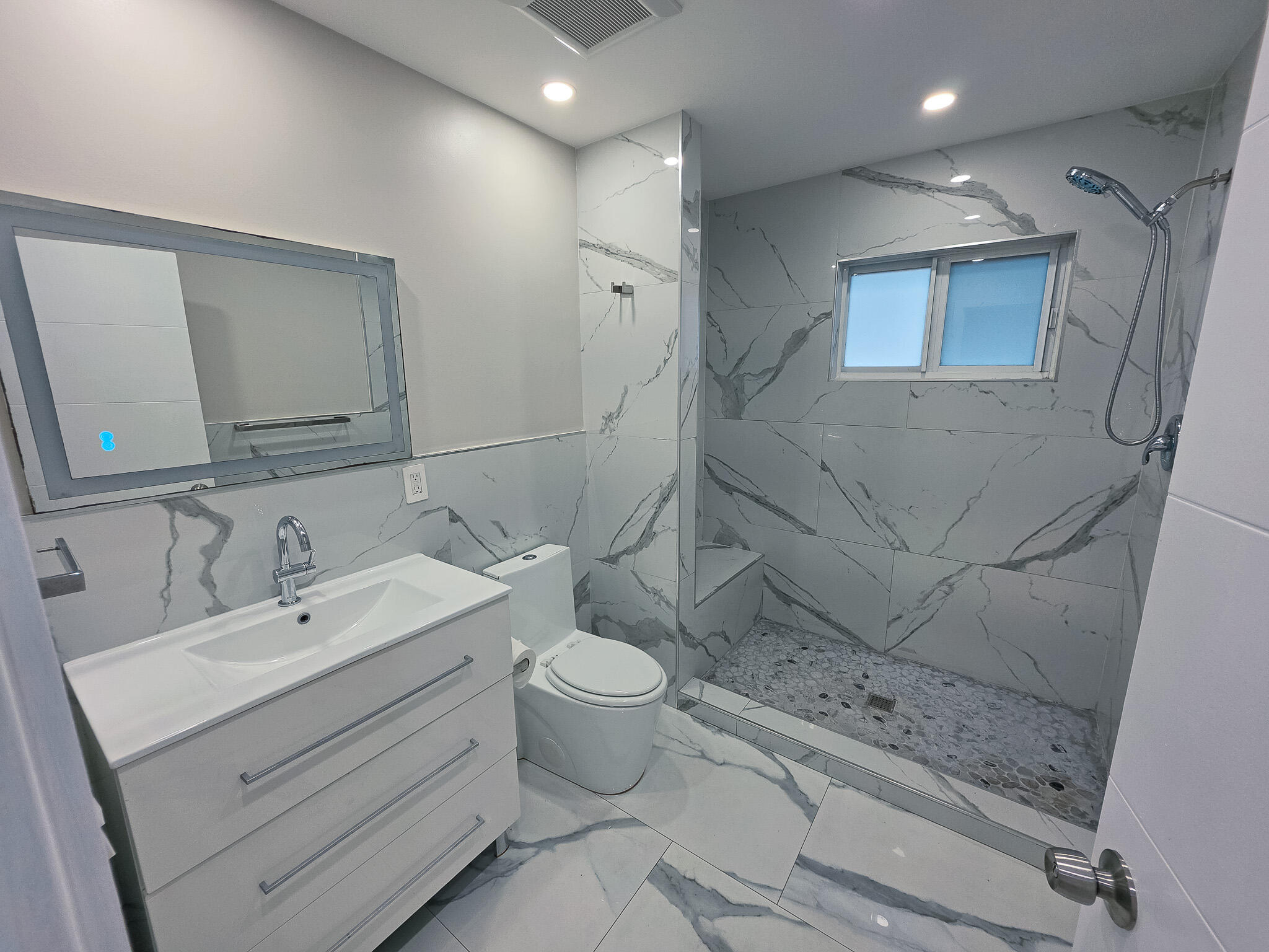 352 Johnston Street Fort Pierce, FL 34982 - Photo 18 of 28 a bathroom with a sink mirror and toilet