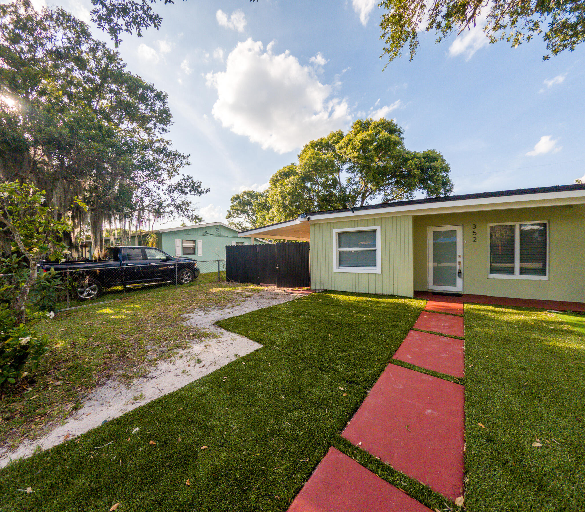 352 Johnston Street Fort Pierce, FL 34982 - Photo 2 of 28 a front view of a house with a yard