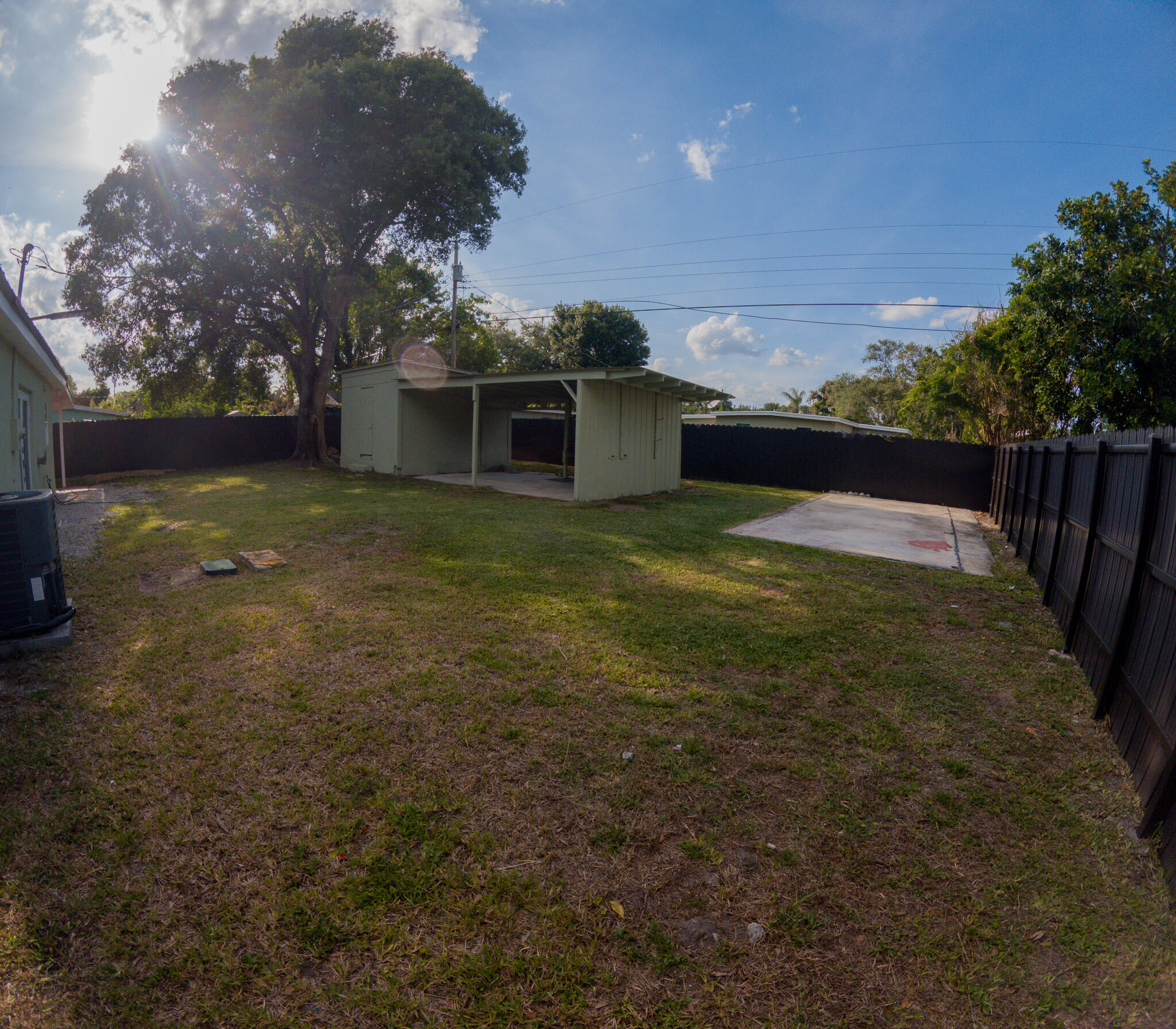 352 Johnston Street Fort Pierce, FL 34982 - Photo 21 of 28 a view of a yard in front of a house with a large tree