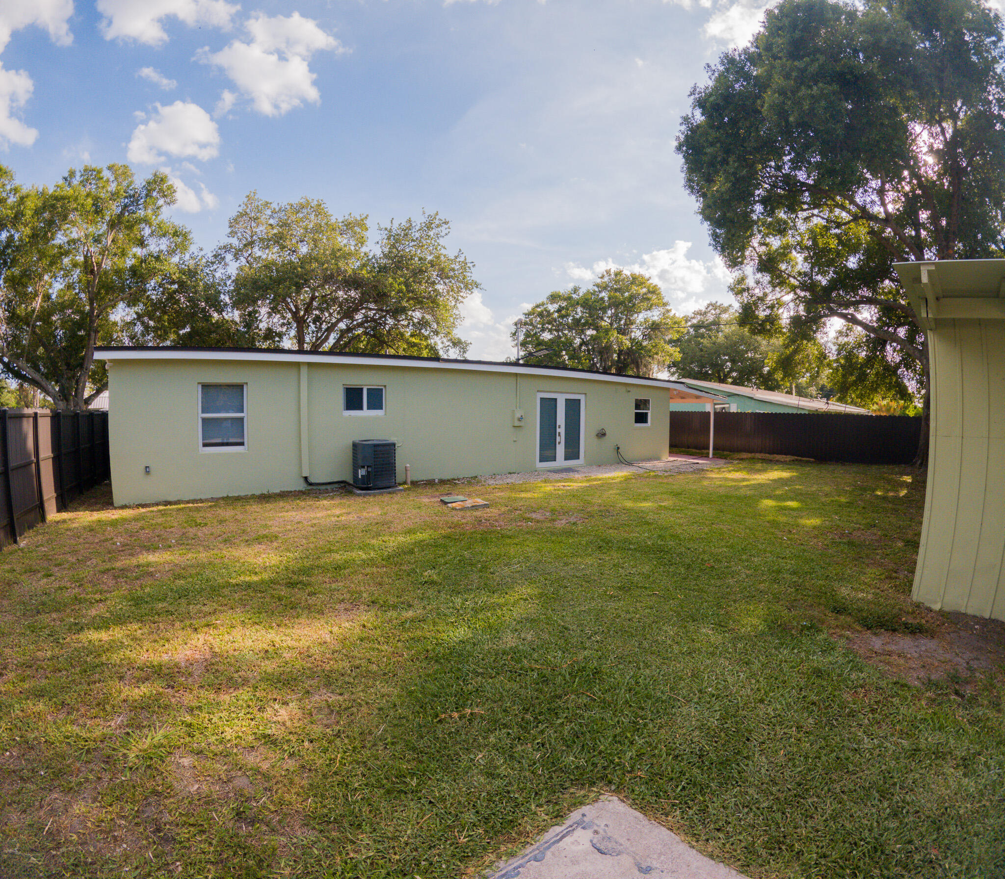 352 Johnston Street Fort Pierce, FL 34982 - Photo 22 of 28 a front view of house with yard and trees