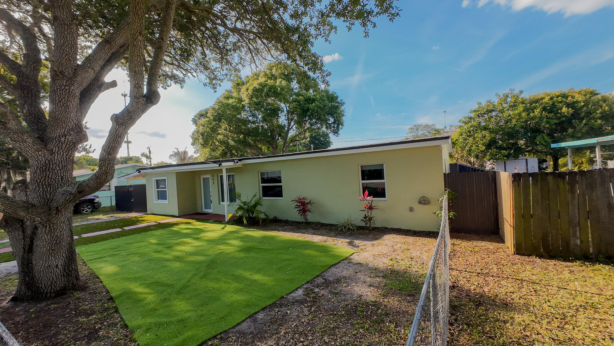 352 Johnston Street Fort Pierce, FL 34982 - Photo 28 of 28 a view of a house with a yard and tree