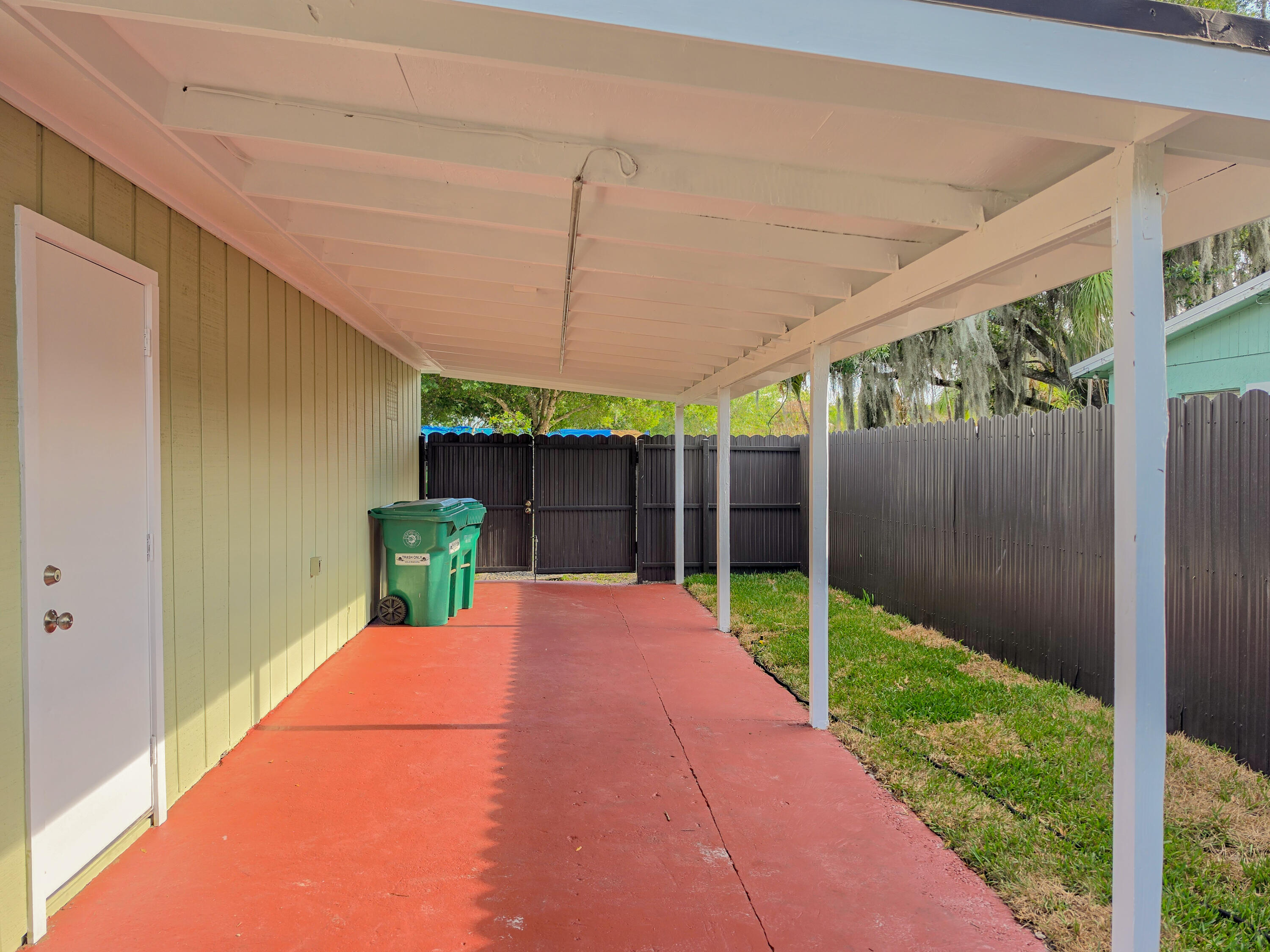 352 Johnston Street Fort Pierce, FL 34982 - Photo 5 of 28 a view of a backyard with wooden fence