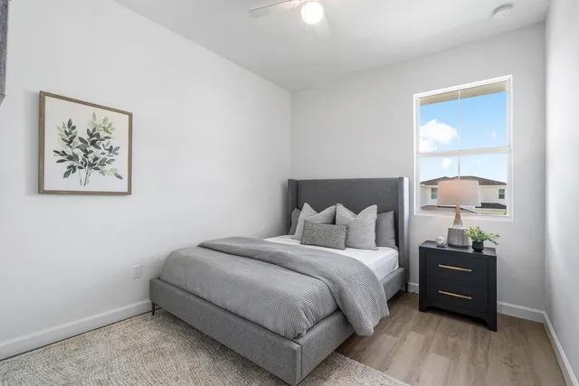 a bedroom with a bed and a night stand