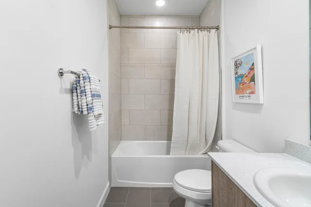 a bath room with a toilet a sink and a bath tub