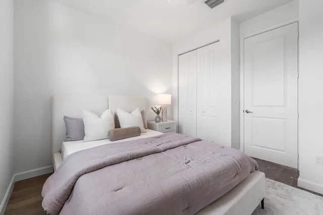 a bedroom with a bed and a closet