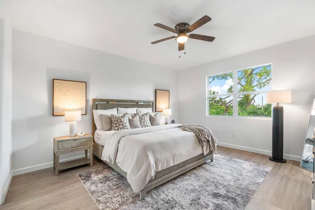 a bedroom with a large bed and a large window