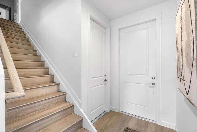 a view of an entryway with wooden floor