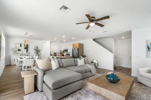 a living room with furniture and a wooden floor