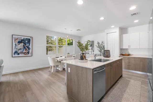 a kitchen with a sink and wooden floor