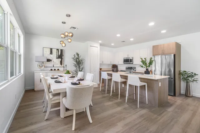 a view of a dining room with furniture and wooden floor