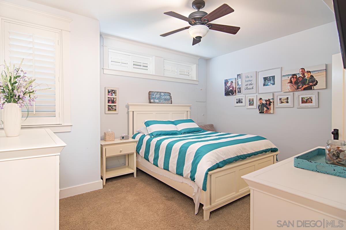 918 D Coronado Ca Coronado, CA 92118 - Photo 16 of 27 a bedroom with a bed and a chandelier