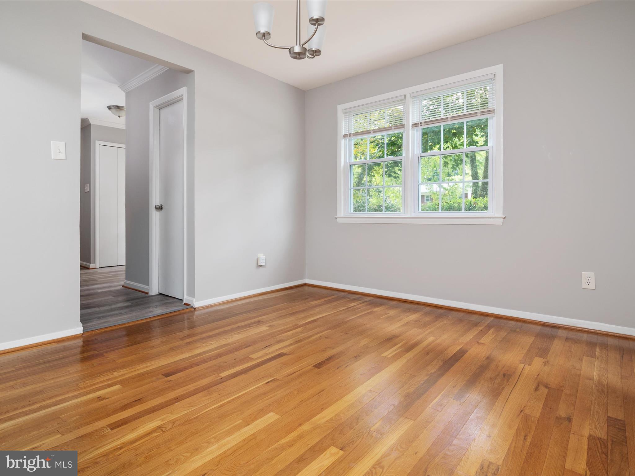 806 Downs Drive Silver Spring, MD 20904 - Photo 12 of 36 an empty room with wooden floor and windows