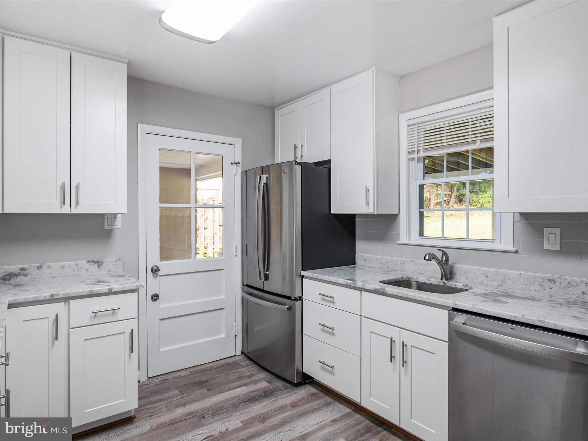 806 Downs Drive Silver Spring, MD 20904 - Photo 13 of 36 a kitchen with white cabinets and sink