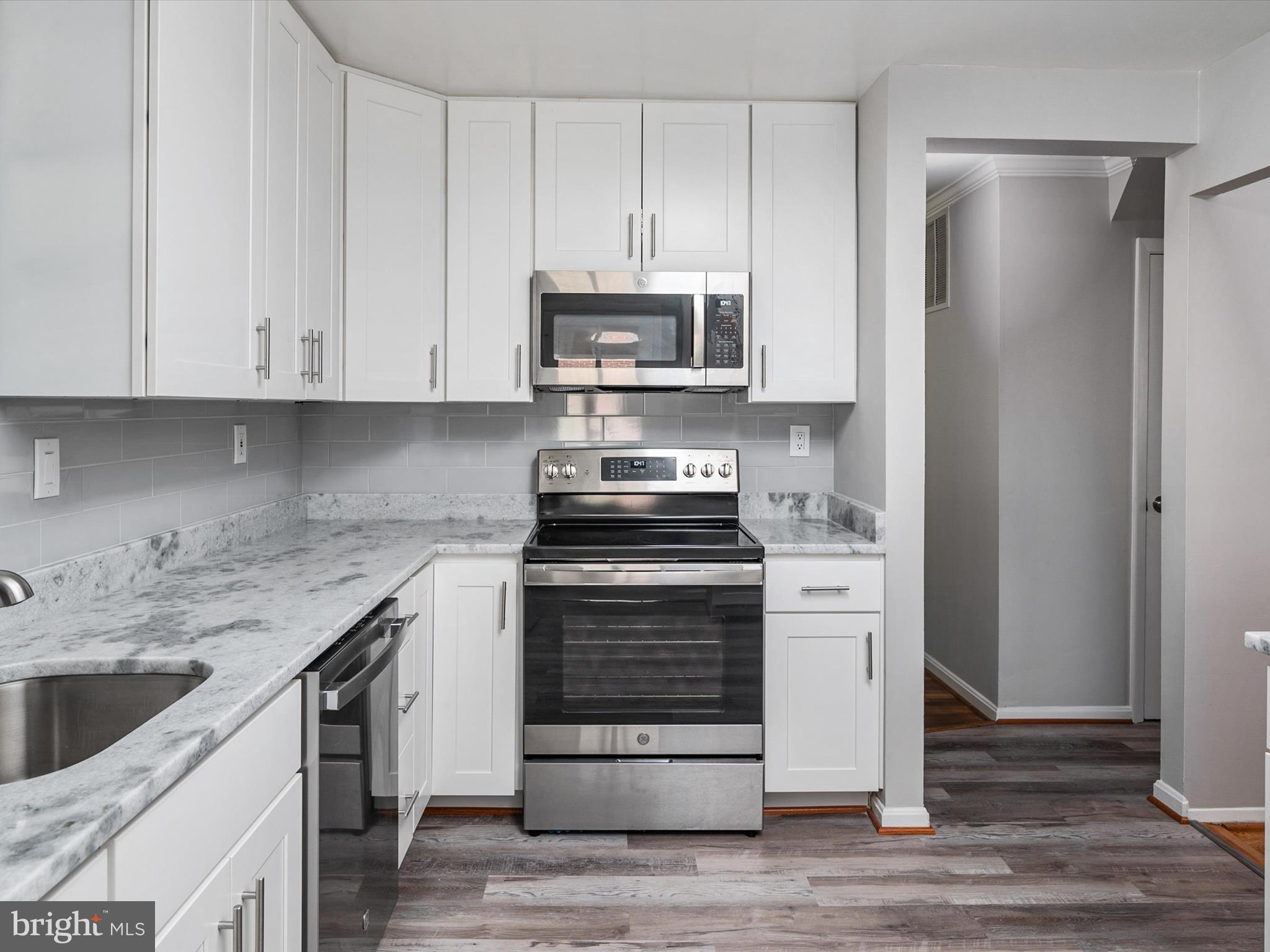 806 Downs Drive Silver Spring, MD 20904 - Photo 15 of 36 a kitchen with stainless steel appliances granite countertop a stove and a refrigerator