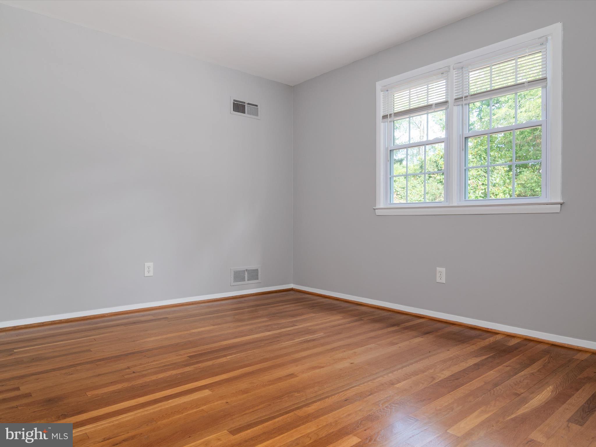 806 Downs Drive Silver Spring, MD 20904 - Photo 23 of 36 an empty room with wooden floor and windows