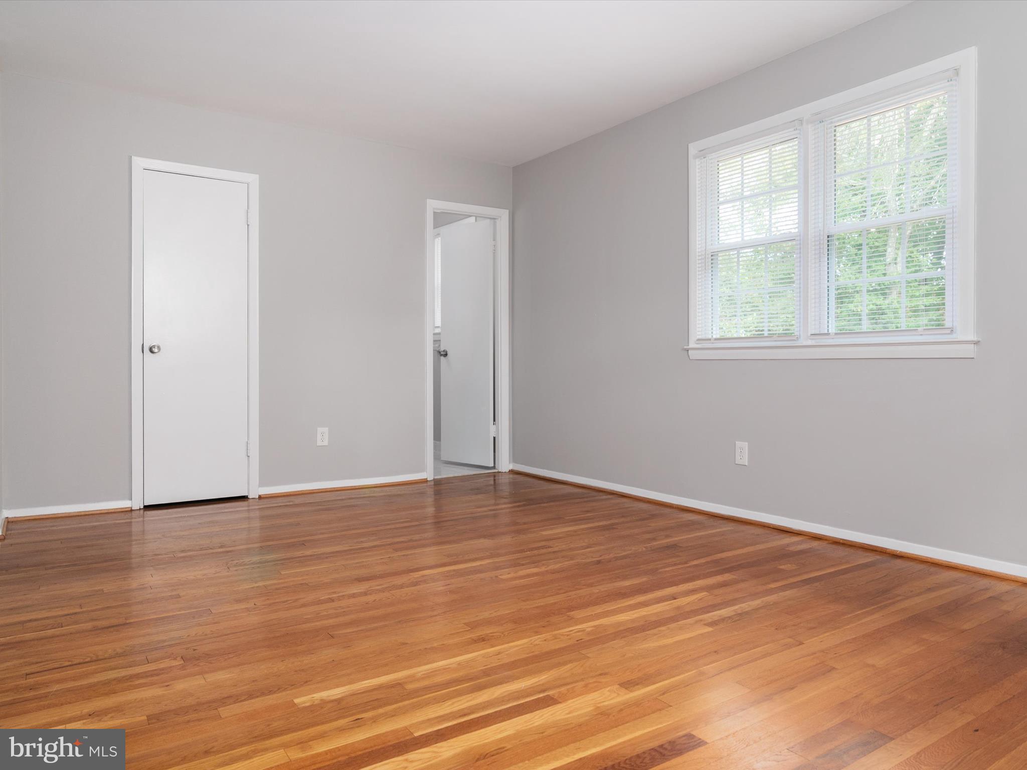 806 Downs Drive Silver Spring, MD 20904 - Photo 26 of 36 a view of an empty room with wooden floor and a window