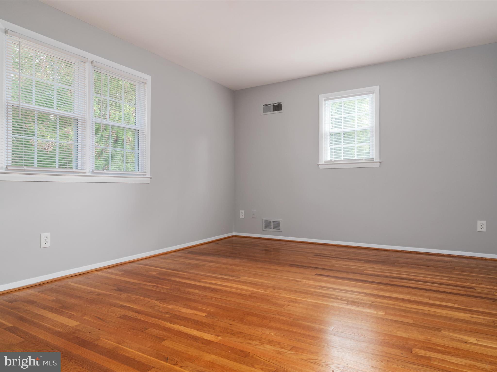 806 Downs Drive Silver Spring, MD 20904 - Photo 27 of 36 an empty room with wooden floor and windows