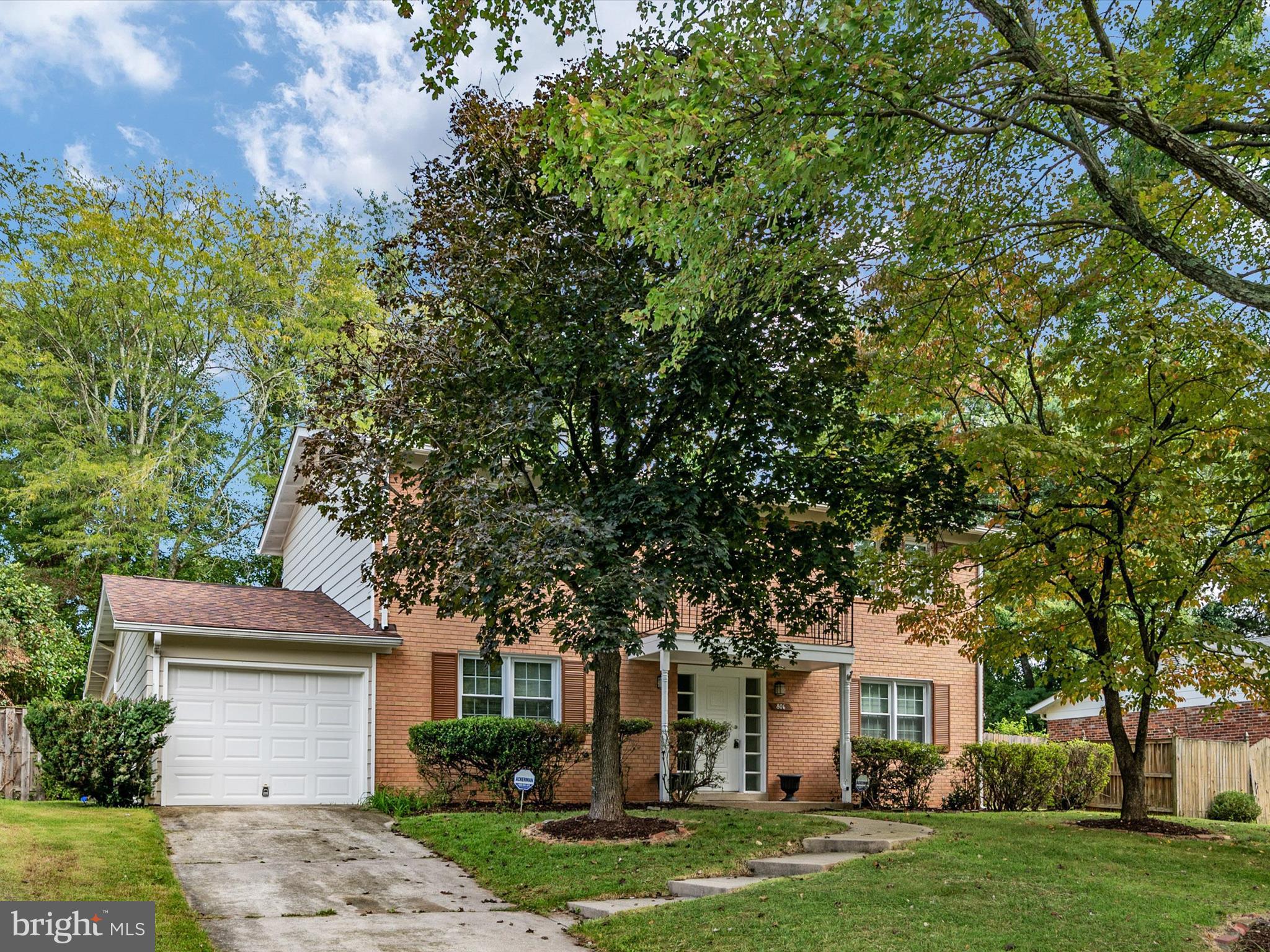 806 Downs Drive Silver Spring, MD 20904 - Photo 3 of 36 a front view of a house with a garden and trees