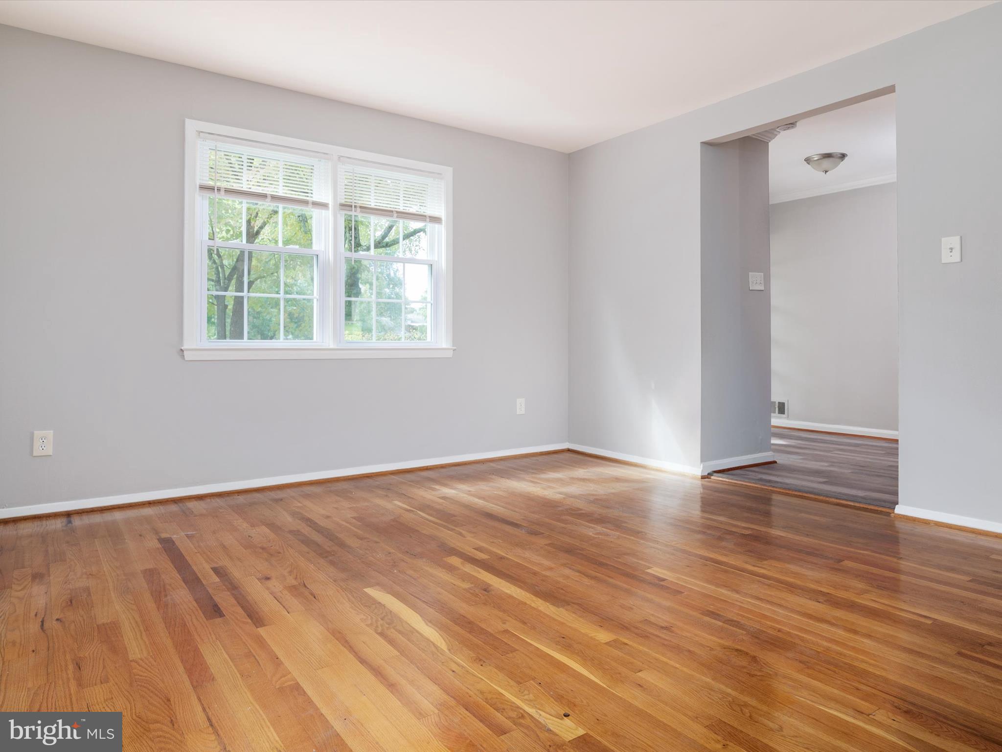 806 Downs Drive Silver Spring, MD 20904 - Photo 8 of 36 an empty room with wooden floor and windows