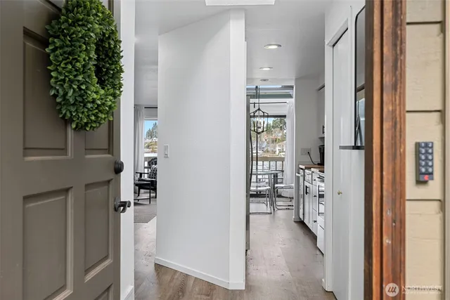 a living room with furniture a fireplace and a floor to ceiling window