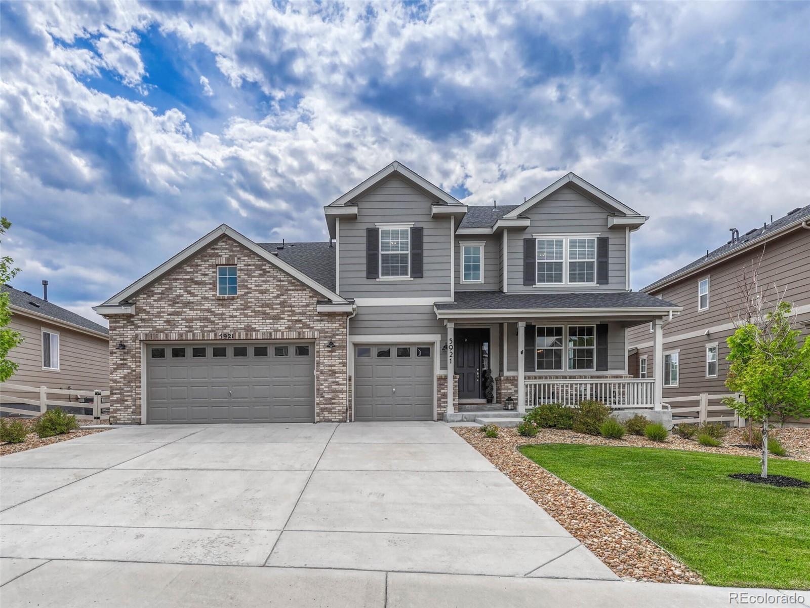 5921 Berry Ridge Wy. Castle Rock, CO 80104 - Photo 2 of 43 a front view of a house with a yard and garage