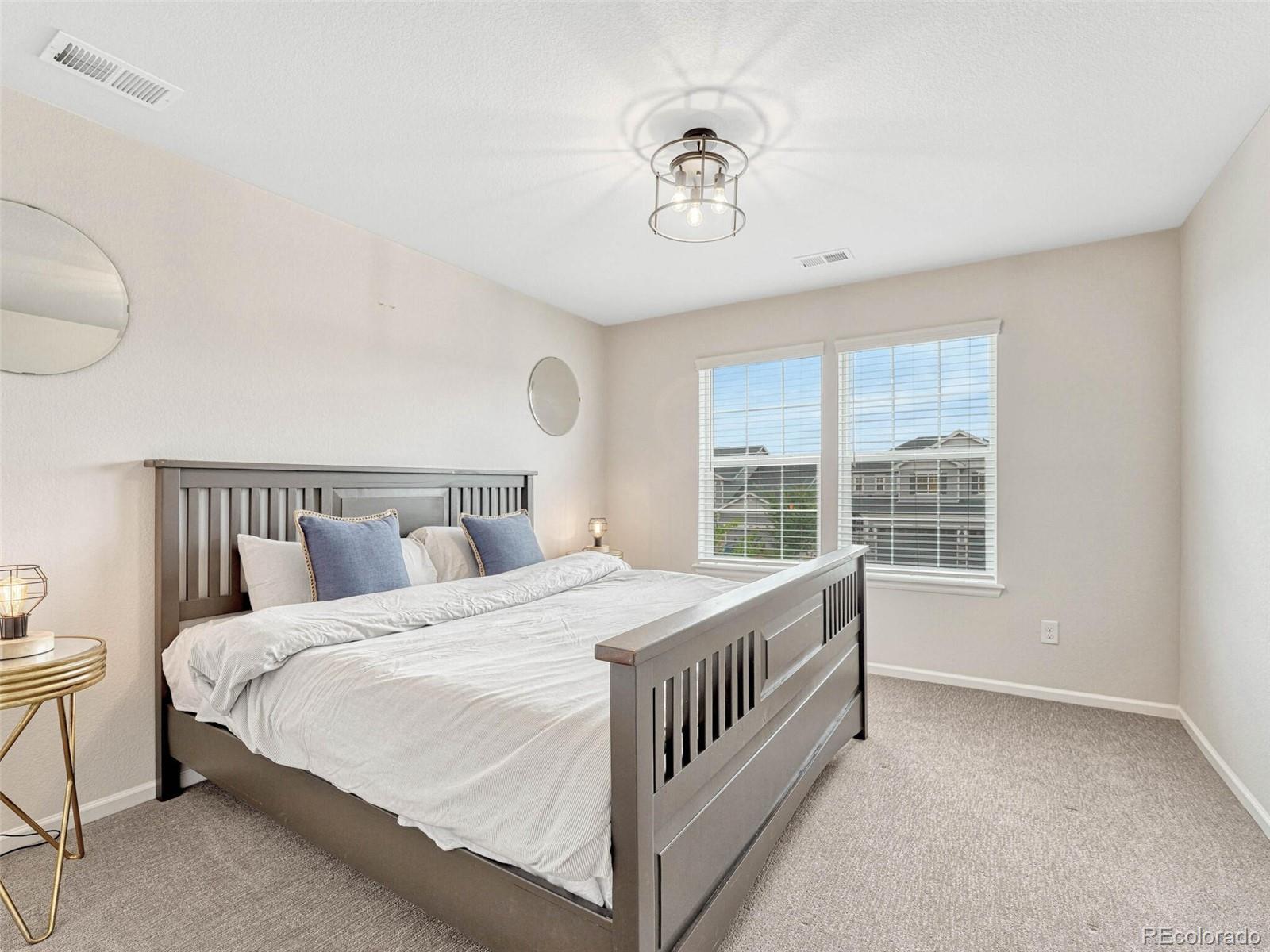5921 Berry Ridge Wy. Castle Rock, CO 80104 - Photo 30 of 43 a bedroom with a large bed and a window