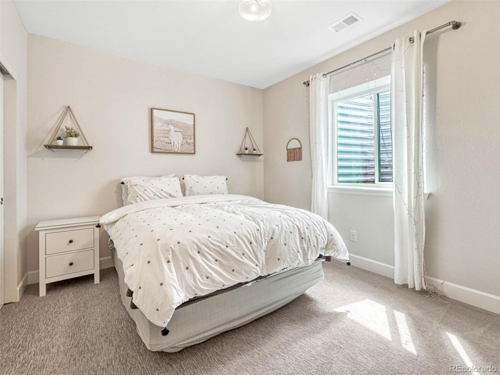 5921 Berry Ridge Wy. Castle Rock, CO 80104 - Photo 36 of 43 a spacious bedroom with a bed and a window