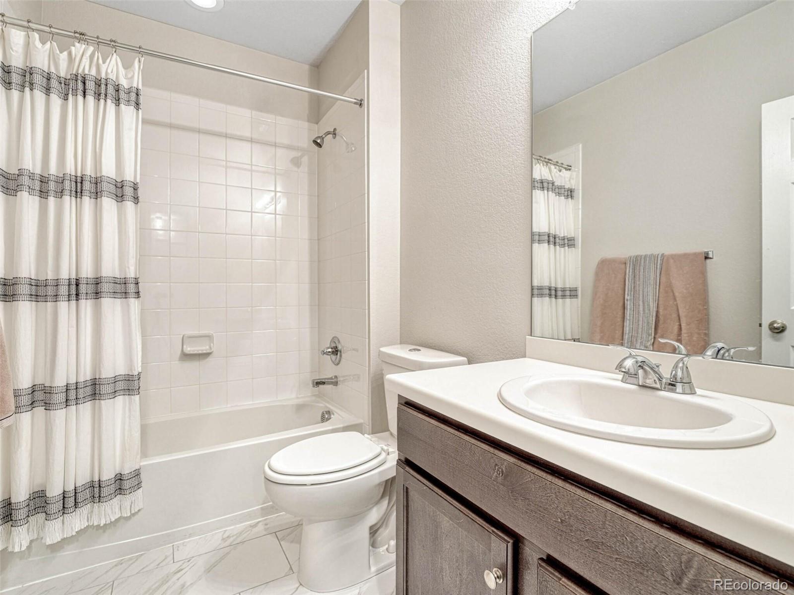 5921 Berry Ridge Wy. Castle Rock, CO 80104 - Photo 37 of 43 a bathroom with a sink a toilet and shower