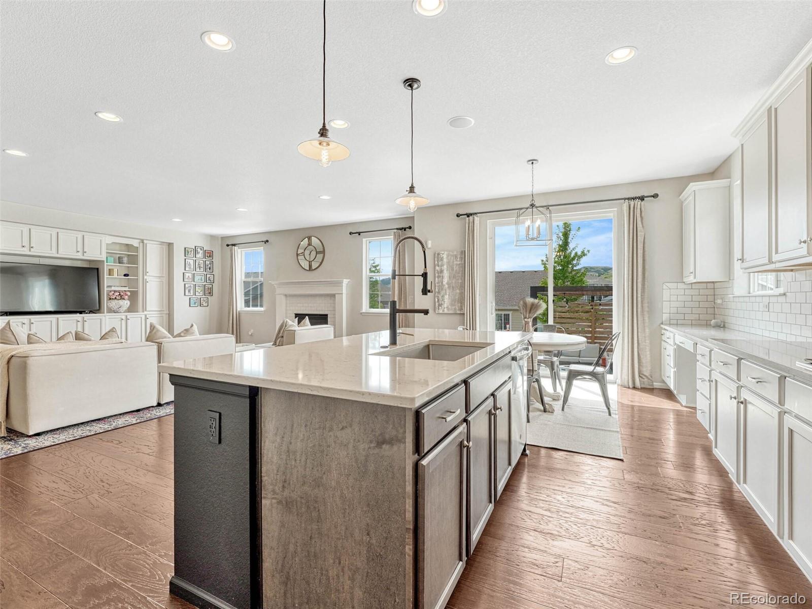 5921 Berry Ridge Wy. Castle Rock, CO 80104 - Photo 10 of 43 a kitchen with counter top space sink and center island