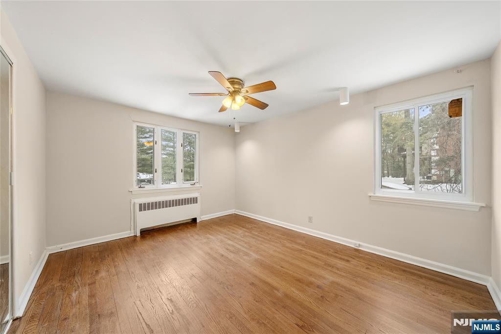 44 Knickerbocker Road Cresskill, NJ 07626 - Photo 13 of 26 a view of an empty room with a window and wooden floor